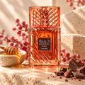 Lattafa Khamrah Mira by Lattafa EDP Unisex — Amber glass perfume bottle with a textured cap, next to its pink and blue watercolor-style box with gold accents.