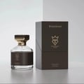 Bujairami Kingsman — A clear glass perfume bottle with a black leather band and gold accents sits next to its dark brown