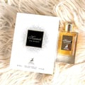 Maison Alhambra Kismet for Women 100ml by Maison Alhambra — A white box and a clear glass perfume bottle with gold accents and a deer emblem, displayed against a white background. | Maison Alhambra Kismet for Women 100ml by Maison Alhambra — Peti putih dan botol minyak wangi kaca jernih dengan perincian emas dan