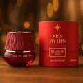 Maison Asrar Kiss My Lips by Maison Asrar 90ml EDP Unisex — Red cylindrical packaging with gold accents, featuring 'KISS MY LIPS' and 'MAISON ASRAR' text. The perfume bottle has a textured, deep red cap and a black base with gold trim, displaying 'Kiss My Lips' and volume details.