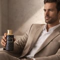 Maison Asrar Legacy by Maison Asrar 100ml EDP Unisex — Blue cylindrical box and matching perfume bottle with gold accents and intricate geometric pattern