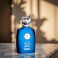 Maison Alhambra Leyden Eau De Parfum — A dark blue perfume bottle and its matching striped box are displayed side-by-side against a white background. The box features two white horses and a circular emblem. | Maison Alhambra Leyden Eau De Parfum — Botol minyak wangi biru gelap dan kotaknya yang berjalur dipamerkan