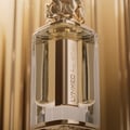 Afnan Lynked Forever by Afnan 100ml Eau De Parfum — A gold-capped perfume bottle stands next to its rose gold box with