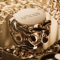Afnan Lynked Forever by Afnan 100ml Eau De Parfum — A gold-capped perfume bottle stands next to its rose gold box with