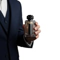 Afnan Lynked Freedom by Afnan — Gray gift box with embossed circle and text, next to a clear glass perfume bottle with black