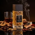 Bujairami Mafia Boss — Clear glass perfume bottle with gold liquid next to a black presentation box with gold logo and text