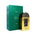 Lattafa Pride Maharjan Gold — A gold perfume bottle with a black and gold mosaic cap sits next to its matching ornate dark green box, both on a white background. | Lattafa Pride Maharjan Gold — Botol minyak wangi emas dengan penutup mozek hitam dan emas duduk di sebelah kotaknya yang berhias hijau gelap, kedua-duanya