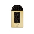 Lattafa Pride Maharjan Gold — A gold perfume bottle with a black and gold mosaic cap sits next to its matching ornate dark green box, both on a white background. | Lattafa Pride Maharjan Gold — Botol minyak wangi emas dengan penutup mozek hitam dan emas duduk di sebelah kotaknya yang berhias hijau gelap, kedua-duanya