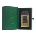 Lattafa Pride Maharjan Gold — A gold perfume bottle with a black and gold mosaic cap sits next to its matching ornate dark green box, both on a white background. | Lattafa Pride Maharjan Gold — Botol minyak wangi emas dengan penutup mozek hitam dan emas duduk di sebelah kotaknya yang berhias hijau gelap, kedua-duanya