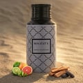 Maison Asrar Majesty by Maison Asrar 100ml EDP Unisex — A grey bottle with a repeating black quatrefoil pattern and a black textured cap, featuring a black label with 'MAJESTY' and 'ROYAL COLLECTION' text.
