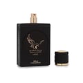 Lattafa Malik Al Tayoor Concentrated 100ml — Black perfume bottle and its black textured box with a golden eagle emblem and Arabic text, set against a white background. | Lattafa Malik Al Tayoor Concentrated 100ml — Botol minyak wangi hitam dan kotaknya yang bertekstur hitam dengan lambang helang emas dan teks Arab