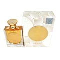 Ard Al Zaafaran Mithqal 100ml — A clear glass perfume bottle with gold liquid and a circular gold emblem, next to its white and gold patterned box with a matching emblem. | Ard Al Zaafaran Mithqal 100ml — Botol minyak wangi kaca jernih dengan cecair emas dan lambang emas bulat, bersebelahan dengan kotak corak putih