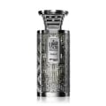 Zimaya Modhesh Noble 100ml — A silver patterned gift box stands next to a matching silver patterned perfume bottle with a metallic cap, both on a white background. | Zimaya Modhesh Noble 100ml — Kotak hadiah bercorak perak berdiri di sebelah botol minyak wangi bercorak perak yang sepadan dengan penutup logam