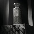 Zimaya Modhesh Noble 100ml — A silver patterned gift box stands next to a matching silver patterned perfume bottle with a metallic cap, both on a white background. | Zimaya Modhesh Noble 100ml — Kotak hadiah bercorak perak berdiri di sebelah botol minyak wangi bercorak perak yang sepadan dengan penutup logam