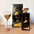 Gulf Orchid Moonlight Eau De Parfum — Black bottle with gold desert dunes and crescent moon design, gold cap | Gulf Orchid Moonlight Eau De Parfum — Botol hitam dengan reka bentuk bukit pasir emas dan bulan sabit, penutup emas