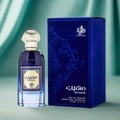 Al Wataniah Muheeb Perfume Man by Al Wataniah 100ml — A dark blue perfume bottle with a gold cap sits next to its matching dark blue box with ornate gold Arabic calligraphy and floral designs. | Al Wataniah Muheeb Perfume Man by Al Wataniah 100ml — Botol minyak wangi biru gelap dengan penutup emas terletak di sebelah