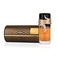 Lattafa Musamam Eau De Parfum 100ml by Lattafa — A gold snake wraps around a clear glass perfume bottle filled with amber liquid, next to a textured brown cylindrical box. | Lattafa Musamam Eau De Parfum 100ml by Lattafa — Ular emas melilit botol minyak wangi kaca jernih berisi cecair ambar, bersebelahan kotak