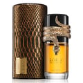 Lattafa Musamam Eau De Parfum 100ml by Lattafa — A gold snake wraps around a clear glass perfume bottle filled with amber liquid, next to a textured brown cylindrical box. | Lattafa Musamam Eau De Parfum 100ml by Lattafa — Ular emas melilit botol minyak wangi kaca jernih berisi cecair ambar, bersebelahan kotak