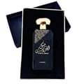 Lattafa Musk Al Aroos by Lattafa 80ml EDP — A black perfume box with gold ornate cutouts and Arabic calligraphy sits next to a dark glass perfume bottle with a gold cap and matching ornate design. | Lattafa Musk Al Aroos by Lattafa 80ml EDP — Kotak minyak wangi hitam dengan potongan berukir emas dan kaligrafi Arab