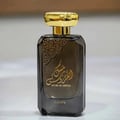 Lattafa Musk Al Aroos by Lattafa 80ml EDP — A black perfume box with gold ornate cutouts and Arabic calligraphy sits next to a dark glass perfume bottle with a gold cap and matching ornate design. | Lattafa Musk Al Aroos by Lattafa 80ml EDP — Kotak minyak wangi hitam dengan potongan berukir emas dan kaligrafi Arab