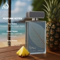 Lattafa Najdia Intense Men Lattafa 100ml EDP — A clear glass perfume bottle with a grey cap and a prominent silver leaf design on the front, placed next to its matching grey and blue box with a similar silver leaf motif.