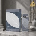 Lattafa Najdia Intense Men Lattafa 100ml EDP — A clear glass perfume bottle with a grey cap and a prominent silver leaf design on the front, placed next to its matching grey and blue box with a similar silver leaf motif.