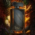 Lattafa Najdia Intense Men Lattafa 100ml EDP — A clear glass perfume bottle with a grey cap and a prominent silver leaf design on the front, placed next to its matching grey and blue box with a similar silver leaf motif.