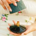 Maison Asrar Never Forget Me by Maison Asrar 90ml EDP Women — Green textured box lid open, revealing a dark bottle with gold accents and textured interior.