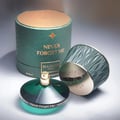Maison Asrar Never Forget Me by Maison Asrar 90ml EDP Women — Green textured box lid open, revealing a dark bottle with gold accents and textured interior.