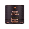 Maison Asrar Night In Paris — Botol minyak wangi hitam bertekstur dengan penutup emas di sebelah kotak silindernya yang hitam dan emas, kedua-duanya bercorak berombak dan tulisan emas.