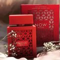 Rave Now Rouge Perfume EDP 100ml by RAVE — A red box with a geometric pattern sits next to an orange perfume bottle with a similar geometric cutout design. | Rave Now Rouge Perfume EDP 100ml by RAVE — Kotak merah dengan corak geometri terletak di sebelah botol minyak wangi oren dengan reka bentuk potongan geometri