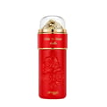 Zimaya Ode to Rose Bella Eau De Parfum — A red perfume bottle with embossed roses and a gold-accented clear cap sits next to its matching red patterned gift box with embossed gold roses. | Zimaya Ode to Rose Bella Eau De Parfum — Botol minyak wangi merah dengan bunga ros timbul dan penutup jernih beraksen emas