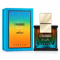 Armaf Ombre Fresh by Armaf 100ml EDP Unisex — Glass perfume bottle with gradient amber-to-teal liquid, gold cap, on a black speckled base, next to its blue gradient box.