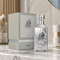 Zimaya Oscar Platinum — Silver perfume bottle and its grey textured box packaging, both featuring black Arabic calligraphy and text.