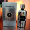Maison Alhambra Panther Pour Homme — White glass perfume bottle with a dark label and a white box with embossed text and a deer logo. | Botol minyak wangi kaca putih Maison Alhambra Panther Pour Homme dengan label gelap dan kotak putih bertekstur timbul serta logo rusa.