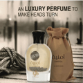 Perfume bottle and packaging with 'Al Wataniah' branding on a blurred background