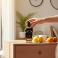 Women perfume bottle in Malaysian home morning light with citrus fruits and coffee – sweet fresh fragrance Malaysia