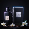 Optimum Noir on black velvet with coffee beans and jasmine, neon rim light; clear bottle and box, high contrast.