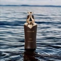 Stellar Oud Khadaj perfume bottle on water