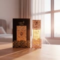 Atheeri bottle and box in Malaysian sunrise with rose‑gold glow and soft vanilla aura; cinematic realism, clear product.