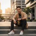 Lelaki Melayu duduk di tangga batu bersama Oud Lail Maleki – gaya urban maskulin Malaysia”