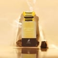 Perfume bottle labeled 'Mysterious Amber' with a decorative cap on a beige background