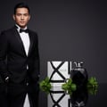Malay man holding Rue Broca Touche Pour Homme perfume bottle and box mint leaves luxury men fragrance Malaysia