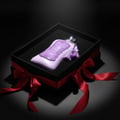 Fatima Velvet Love 100 ml Extrait by Zimaya – Purple perfume bottle in a black box with a red ribbon on a dark background