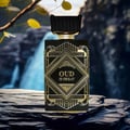 Perfume bottle labeled 'Oud is Great' by Zinqua on a stone surface with a natural background.