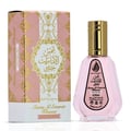 Ard Al Zaafaran Pink Blush Shams Al Emarat Khususi 50ml Perfume — Pink glass perfume bottle with gold spray nozzle and cap, label shows Arabic script and English text, isolated on white background.