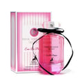 Maison Alhambra Pink Shimmer Secret 100ml — Pink perfume bottle with a black ribbon bow, next to its matching pink striped box, on a white background. | Maison Alhambra Pink Shimmer Secret 100ml — Botol minyak wangi merah jambu dengan reben hitam, bersebelahan kotak berjalur merah jambu yang sepadan, di atas latar
