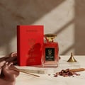 Bujairami Red Static — Red perfume bottle with gold cap next to matching red box with gold logo