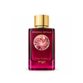 Zimaya Reverie Petals by Zimaya 100ml EDP Women — A woman's hand with dark red nails reaches for the gold cap of a deep red perfume bottle, next to its matching box, surrounded by dark red flowers and delicate white blossoms on a marble surface.