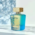 Lattafa Sheikh Al Shuyukh Supreme by Lattafa 100ml — A blue and green faceted glass perfume bottle with a gold textured cap sits next to its blue and light blue patterned box, which features an image of a man in traditional headwear. | Lattafa Sheikh Al Shuyukh Supreme by Lattafa 100ml — Botol kaca berfaset biru dan